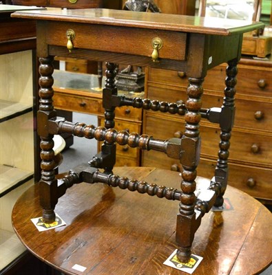 Lot 1154 - An oak side table with bobbin turned legs