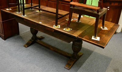 Lot 1208 - An early 20th century carved oak draw leaf table