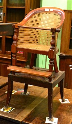 Lot 1210 - A child's caned chair with stand