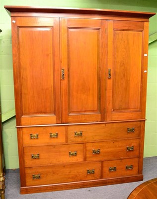 Lot 1215 - An impressive late Victorian triple fronted linen press with wardrobe compartment