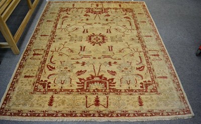 Lot 1235 - A Chobi rug, Afghan/Pakistan, the cream field of angular vines enclosed by floral borders, 199cm by