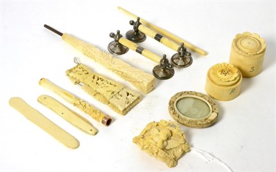 Lot 6 - A carved ivory cruet set, a carved ivory plaque, knife rest, a cheroot holder and a parasol handle