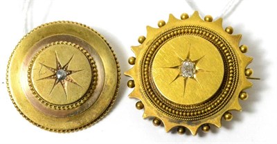 Lot 16 - Circular gold brooch with diamonds, together with a smaller example (2)
