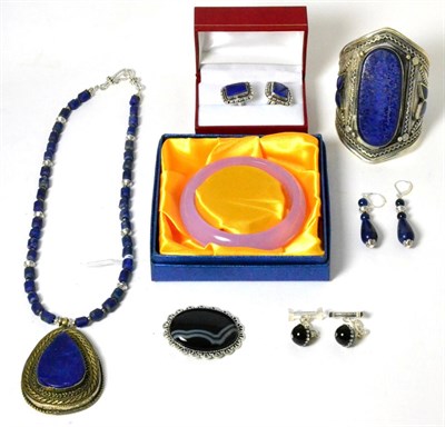 Lot 33 - A lapis lazuli necklace, a lapis lazuli cuff bangle, a pair of lapis lazuli earrings, a pair of...