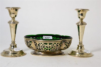 Lot 107 - A pair of loaded silver candlesticks and a silver bowl with liner (3)