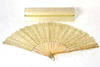 Lot 123 - A late 19th century mother of pearl fan, with floral lace mount, 27cm, in a silk lined fan case