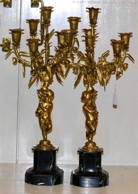 Lot 144 - A pair of gilt metal five-light candelabra in 18th century style, with cherub supports on...