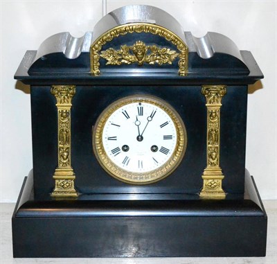 Lot 145 - A black slate striking mantel clock