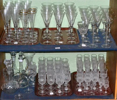 Lot 171 - Two shelves of assorted drinking glasses including champagne flutes and wines together with...