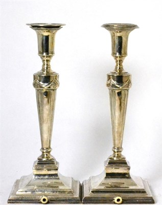 Lot 180 - A pair of silver candlesticks, the bases drilled for electricity