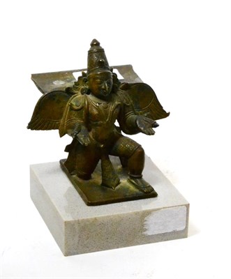 Lot 193 - An Indian bronze modelled as a winged Buddha kneeling, raised on a modern grey marble base,...