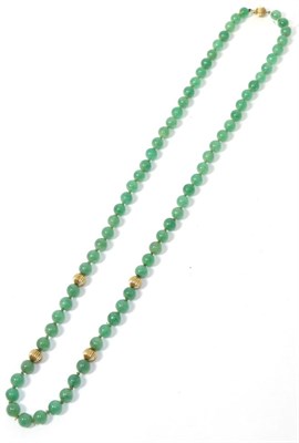 Lot 231 - An adventurine quartz bead necklace with gold bead spacers, stamped '14k'