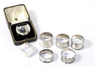 Lot 244 - A group of seven silver napkin rings including a cased example by Elkington, 5.8ozt