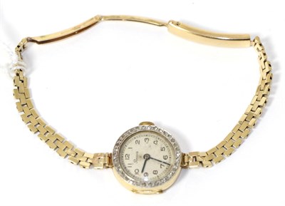 Lot 250 - A lady's gold and diamond set wristwatch