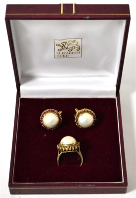 Lot 257 - A pair of mabe pearl and ruby earrings and a matching ring, stamped '750', finger size O