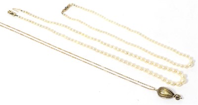 Lot 258 - A citrine set serpent pendant on chain, stamped '15CT' and two pearl necklaces (3)