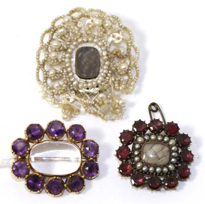 Lot 266 - A garnet and seed pearl mourning brooch, an amethyst mourning brooch and a seed pearl mourning...