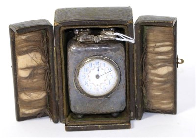 Lot 276 - A small planished silver carriage timepiece, in leather travelling case