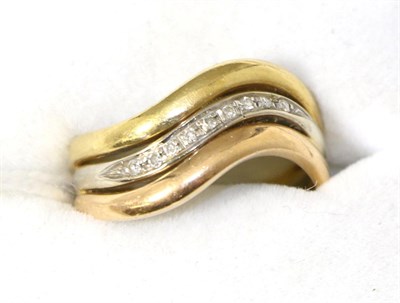 Lot 298 - A diamond set three colour ring, finger size N, stamped '750'