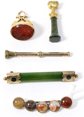 Lot 304 - A fob seal with a crest, a hardstone desk seal, a propelling pencil, a nephrite brooch and a...