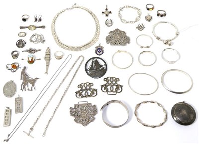 Lot 319 - A compact, three silver bangles, two other bangles, two buckles, a silver fish pendant, two...