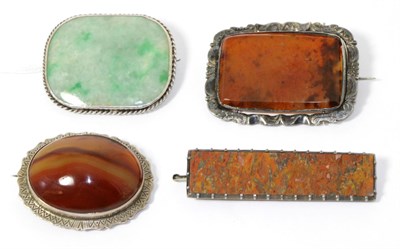 Lot 322 - A jade brooch and three other hardstone brooches (4)