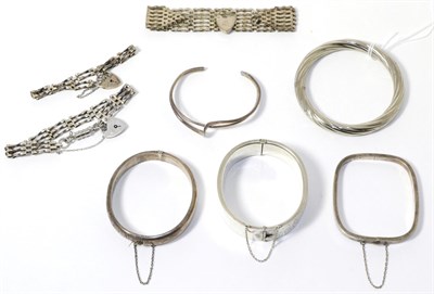 Lot 331 - Two silver hinge opening bangles, three other bangles and three silver gate link bracelets