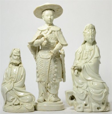 Lot 363 - A Chinese blanc-de-chine figure of a young warrior, 19th century, a seated Guanyin with scroll, and