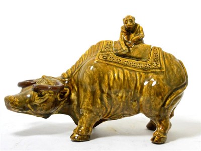 Lot 366 - A Chinese brown glazed model of a water buffalo, a monkey astride its cover, 19th century