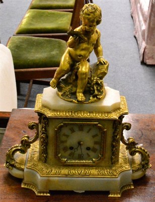 Lot 409 - An onyx and gilt bronze striking mantel clock, surmounted by a Cherub