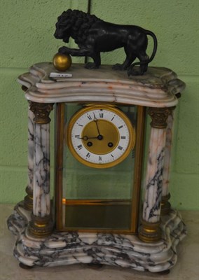 Lot 417 - A marble four glass striking mantel clock, surmounted by a lion