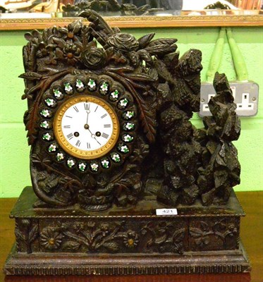 Lot 421 - A carved oak striking mantel clock