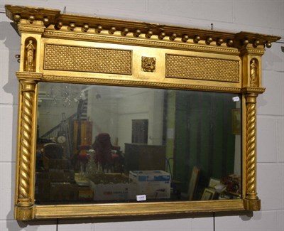 Lot 1068 - A Regency inverted breakfront gilt over mantel mirror