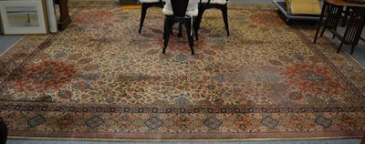 Lot 1103 - A machine made carpet of Oriental design, the cream field centred by an Ardabil medallion framed by