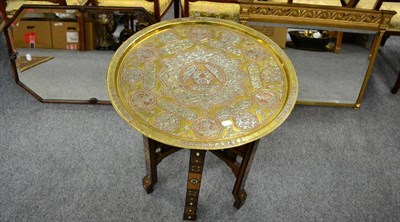 Lot 1127 - Moorish brass and inlaid circular tray top table on folding stand and two framed mirrors (4)