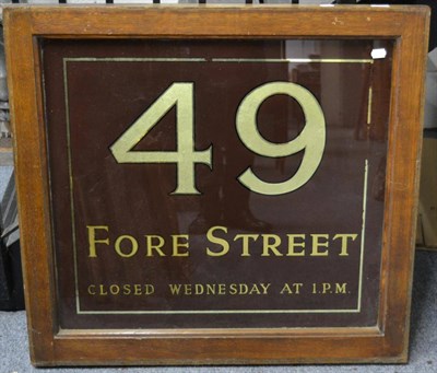 Lot 1140 - An oak framed glass shop door sign