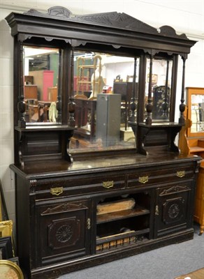 Lot 1147 - A large late Victorian ebonised sideboard, mirrored back, the base with drawers, cupboards and...