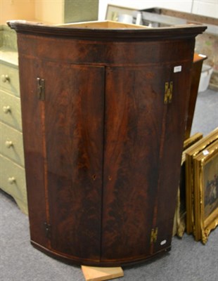 Lot 1182 - A George III flame mahogany bow fronted hanging corner cupboard