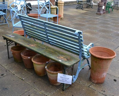 Lot 1194 - A single plank garden bench together with approximately nine terracotta planters