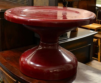 Lot 1212 - A 1970's red fibreglass coffee table, on a pedestal base, unmarked, 60cm diameter, 39cm high