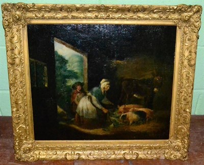 Lot 1256 - Manner of George Morland, woman and child feeding pigs in a barn, oil on panel