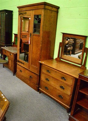 Lot 1286 - Arts & Crafts oak three piece bedroom suite comprising mirror fronted wardrobe with copper...