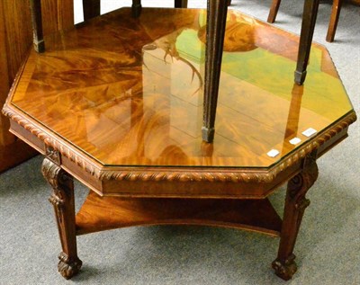 Lot 1303 - A flame mahogany veneered octagonal coffee table with glass protector