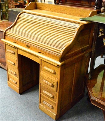 Lot 1304 - An early 20th century oak roll top desk (locked - no key)