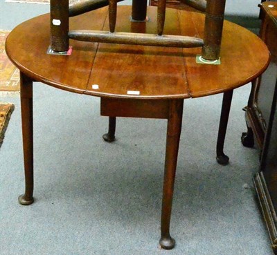 Lot 1317 - A 19th century mahogany circular drop leaf table on pad feet