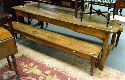 Lot 1348 - A 19th century Provincial oak refectory table, together with two benches (old worm)