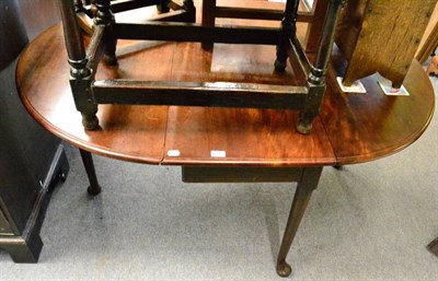 Lot 1365 - A George III mahogany drop flap table on cabriole supports with pad feet