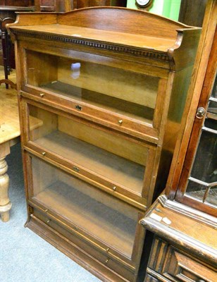 Lot 1373 - An oak sectional bookcase