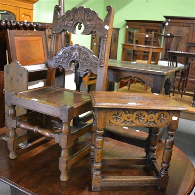 Lot 1374 - A carved oak stool together with a similar chair and an oak magazine rack