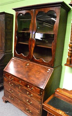 Lot 1385 - A George II mahogany bureau bookcase, 3rd quarter 18th century with a dentil cornice above...